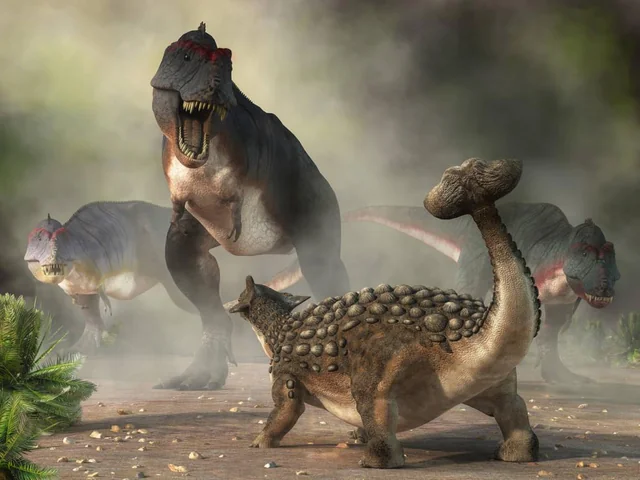 Reconstituição artística de Ankylosaurus em postura defensiva, clube caudal erguido.